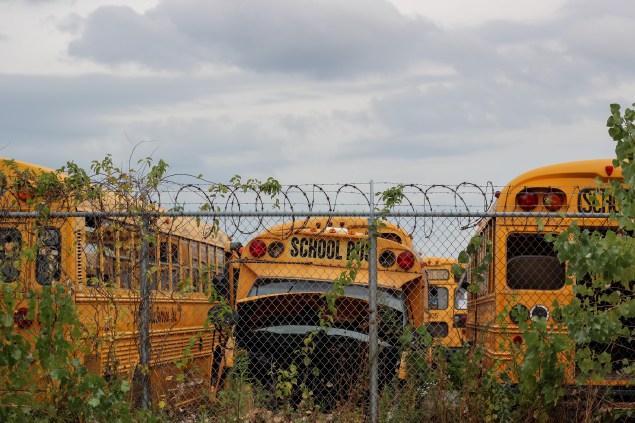 The creepy lot of dead school buses across from our hotel.